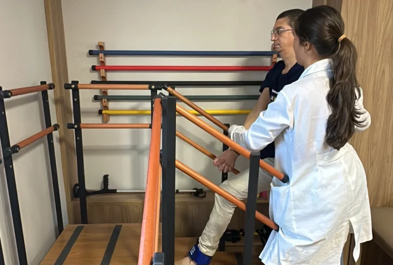 Paciente com esclerose múltipla sendo acompanhado por equipe multidisciplinar em reabilitação